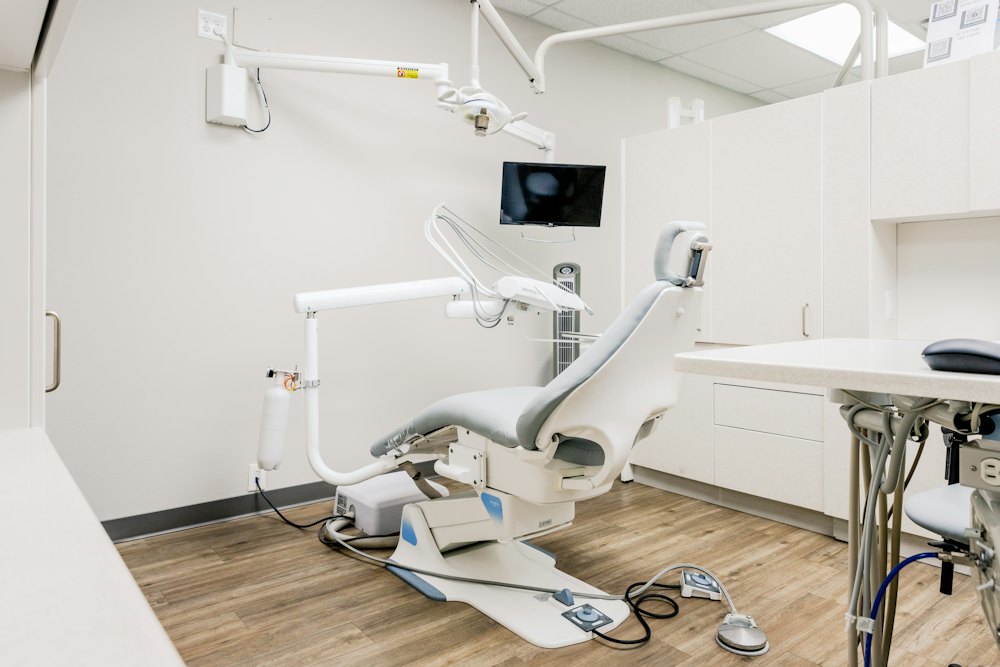 A treatment room with a dental chair and overhead light